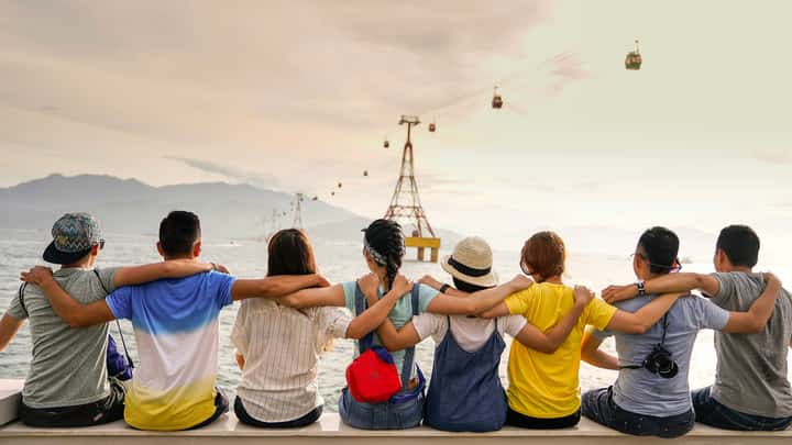 A group of friends toasting around a table